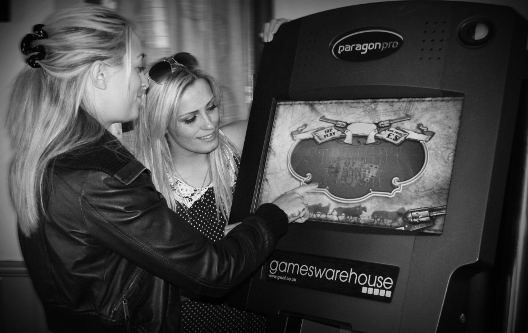 Two women playing a pub quiz machine